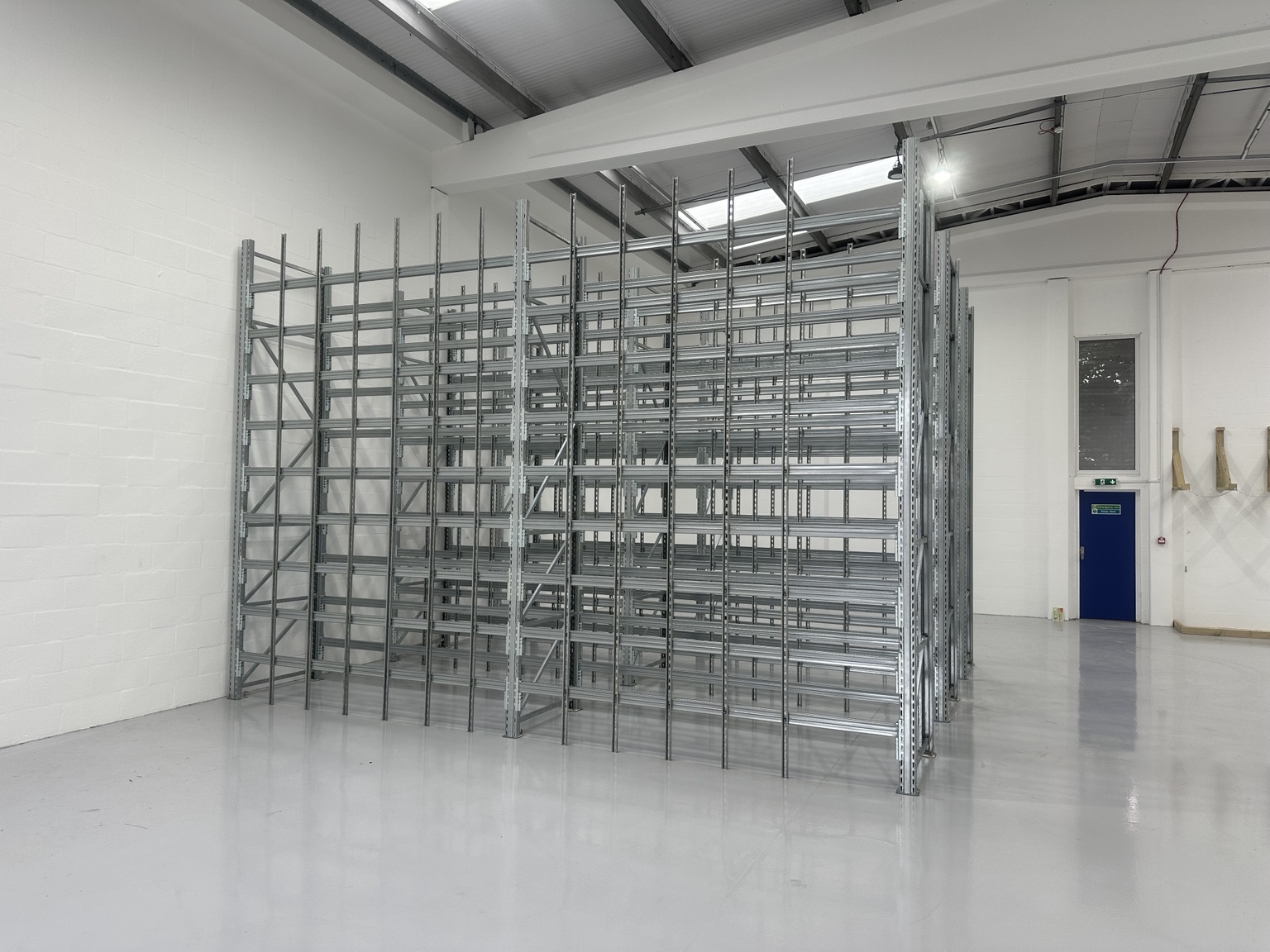 Long item pigeon hole racking installed inside a bright industrial workspace